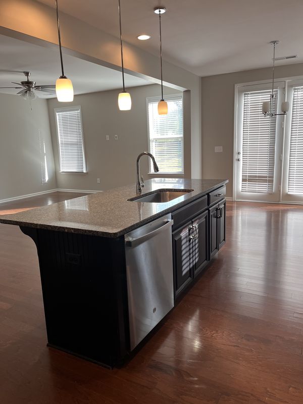 Clean kitchen island with pendant lights