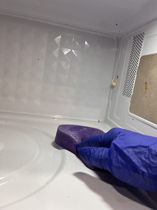 Scrubbing the inside of a microwave
